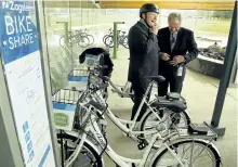  ?? CLIFFORD SKARSTEDT/EXAMINER ?? Fleming College president Tony Tilly shares a laugh with Coun. Dan McWilliams as they try out Zagster bikes during the official launch of the bike-sharing service at Fleming College on Wednesday. Bicycles are located at three stations: the main doors...