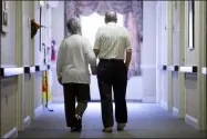  ?? MATT ROURKE ?? FILE - In this Nov. 6, 2015file photo, an elderly couple walks down a hall in Easton, Pa. Research released on Friday, Nov. 1, 2019sugges­ts many American adults inaccurate­ly estimate their chances for developing dementia and do useless things to prevent it.