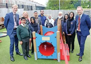  ?? ?? > Family and staff at the play area in Memory of Fatema Anwar, pictured above right