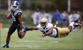  ?? AP PHOTO ?? Duke’s Ryan Smith, left, eludes diving Georgia Tech defender Lawrence Austin during a 68-yard punt return.