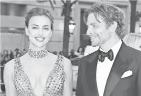  ?? GETTY IMAGES ?? Bradley Cooper, with Irina Shayk, isn’t just a pretty face.