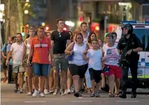  ?? PHOTO: REUTERS ?? Police evacuate people from the Las Ramblas area after the attack, the deadliest terror incident in Spain since March 2004.