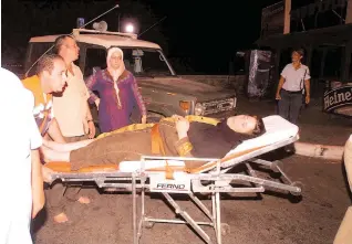 ??  ?? A VICTIM is evacuated after the Taba Hilton bombing, on October 7, 2004. The three Sinai bombing attacks targeting tourist hotels left 34 people dead and 171 injured.