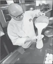  ?? John Ulan/canadian Press ?? Chef Brad Smoliak prepares homemade eggnog in his Edmonton kitchen.