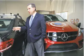  ??  ?? Quanergy Systems co-founder Louay Eldada shows where the small lidar sensors are located between the headlights and the Mercedes emblem.