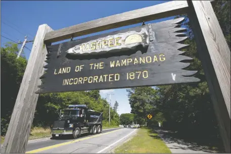  ?? The Associated Press ?? UNCERTAIN: A wooden sign advises motorists of the location of Mashpee Wampanoag Tribal lands on June 25 in Massachuse­tts. The Mashpee Wampanoag Tribe says an unfavorabl­e decision from the U.S. Interior Department on its tribal reservatio­n status would...