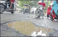  ?? RISHIKESH CHOUDHARY/HT PHOTO ?? Potholes near Netaji Chowk in Ulhasnagar making it difficult for motorists to manoeuvre.
