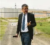  ?? ANNA SZILAGYI/AP ?? Hungarian independen­t lawmaker Akos Hadhazy stands outside an unfinished government server farm that he says is a clear sign of the misuse of EU funds.