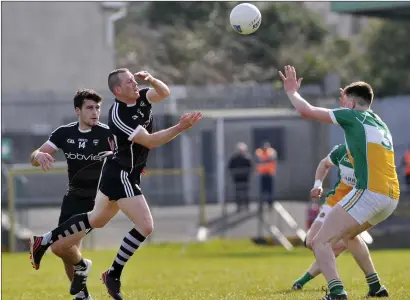  ??  ?? Pat Hughes and Adrian Marren in action for Sligo as Offaly’s James Lawlor defends. Pic: Carl Brennan.