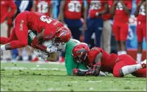  ?? JOEL AUERBACH / GETTY IMAGES ?? Leighton McCarthy (left) and Azeez Al-Shaair (right) converge to tackle North Texas running back Michael Lawrence. McCarthy had a breakout season for the Owls.