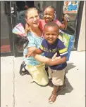  ??  ?? Kidney donor Gwenn Johnson, of Middletown, is shown with Nylah Swinson, 5, at rear, and Terry Swinson, 4, in front, children of her kidney “swap” recipient Terrance Swinson. Terrence Swinson named her godmother to both his kids.