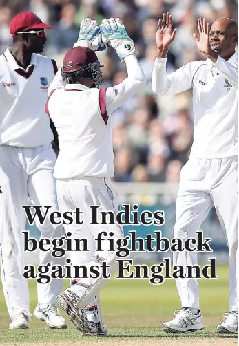  ??  ?? West Indies’ Roston Chase (right) celebrates the wicket of England’s Dawid Malan for 65 during day two of the England versus the West Indies first Test cricket match at Edgbaston, Birmingham, central England, yesterday.