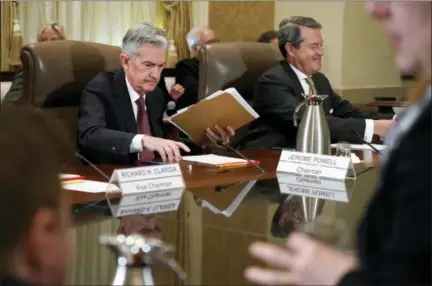  ?? JACQUELYN MARTIN — THE ASSOCIATED PRESS FILE ?? Federal Reserve Chair Jerome Powell, left, and Randal Quarles, vice chair for supervisio­n, gather their things at the end of a Federal Reserve Board meeting at the Marriner S. Eccles Federal Reserve Board Building in Washington.