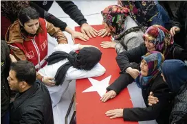  ?? ASSOCIATED PRESS ?? During a funeral ceremony Saturday in Hatay, Turkey, mourners surround the coffin of Emin Yildirim, one of the 33 Turkish soldiers killed Thursday in a Syrian army attack in the Idlib area of Syria, in the worst single incidence of loss of life for Turkey since it entered the Syrian conflict in 2016.