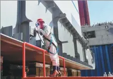  ?? CHEN MENGZE / FOR CHINA DAILY ?? A welder works on assembling China’s first large cruise ship in Shanghai on Tuesday.