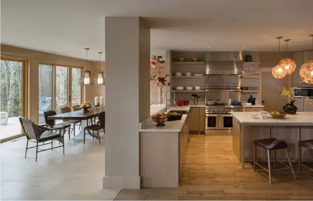  ??  ?? come on over The adjoining kitchen and dining areas are perfect for entertaini­ng; The clean lines of the fireplace exude a modern feel