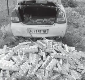  ??  ?? One of the abandoned luxury vehicles and an assortment of smuggled cigarettes