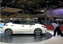  ?? ROB MAETZIG ?? An onlooker gets up close to a Nissan Leaf on display at last year’s Tokyo Motor Show.
