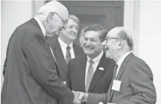  ?? FILE PHOTO BY JAY WESTCOTT FOR USA TODAY ?? Former Fed chiefs Paul Volcker, left, and Alan Greenspan say their hellos as Jeffrey Lacker looks on ahead of an event commemorat­ing the signing of the Federal Reserve Act in 2013.