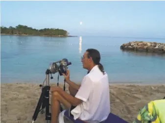  ?? Courtesy Bill Kramer 2015 ?? Eclipse aficionado Bill Kramer adjusts his telescope for the 2015 lunar eclipse in Jamaica.