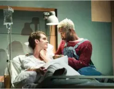  ?? HELEN MAYBANKS/THE NEW YORK TIMES ?? Andrew Garfield (left) and Nathan Stewart perform in National Theatre’s production of Angels in America, a play about the 1980s AIDS crisis.