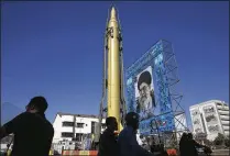  ?? ASSOCIATED PRESS 2016 ?? A Ghadr-F missile is displayed next to a portrait of Iranian Supreme Leader Ayatollah Ali Khamenei at a Revolution­ary Guard hardware exhibition in downtown Tehran. Many military technologi­es can be developed, at least in early stages, indoors. Missiles...
