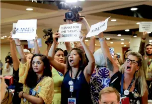  ?? AP ?? Protesters heckle DNC chairwoman Debbie Wasserman Schultz as she arrives for the Florida delegation breakfast on the first day of the Democratic National Convention on Monday. —