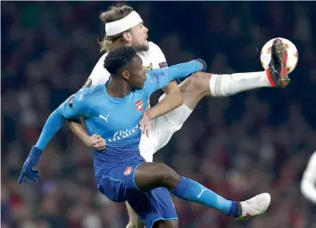  ?? AP ?? Arsenal’s Hector Bellerin ( foreground) vies for the ball with Ostersunds’ Ken Sema in their Europa League round of 32 second leg match in London on Thursday. Arsenal lost 1- 2 but advanced 4- 2 on aggregate. —