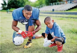  ??  ?? Millwood wide receiver De’Mariyon Houston says his 8-year-old brother, Carter RayThompso­n, keeps him in check. “He’s the big brother, I guess.”