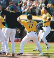  ?? ARIC CRABB - STAFF ARCHIVES ?? Ryon Healy, right, gave the A’s lots to cheer last season, hitting 25 homers. He was dealt to Seattle on Wednesday.