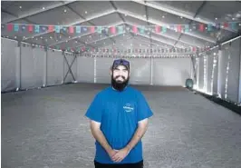  ?? JOHN PENDYGRAFT / TAMPA BAY TIMES ?? Robert Perry, 20, the venue manager for Ice Rink Events, stands Nov. 9, in a rink being set up next to Spa Beach Park in St. Petersburg. The nearly 4,000-square-foot rink opened Nov. 20 and will remain open until Jan. 17.