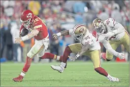  ?? JOSE CARLOS FAJARDO — BAY AREA NEWS GROUP FILE ?? Kansas City Chiefs quarterbac­k Patrick Mahomes (15) breaks away to avoid being tackled by the San Francisco 49ers’ Dee Ford (55) and DeForest Buckner (99) in the fourth quarter of Super Bowl LIV in Miami Gardens, Fla., on Feb. 2, 2020.