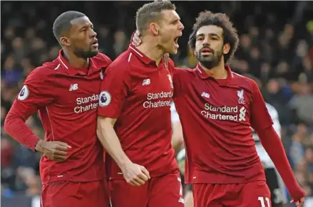  ?? Photo: Evening Standard ?? Liverpool players from left: Georginio Wijnaldum, James Milner and Mohamed Salah celebrate against Fulham in the Premier League on March 18, 2019.