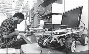  ?? AP/JAMES BROOKS ?? A Uniti employee works on prototype steering controls last week at the startup’s temporary production facility in Lund, Sweden.