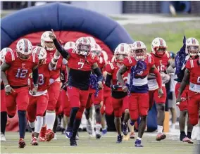  ?? Tim Warner/Contributo­r ?? Lamar’s Jordan Reaves (7) and Kenneth Rosenthal (12) lead the team onto the field for Friday night’s game against Pasadena Dobie at Delmar Stadium.