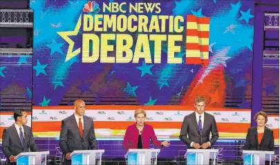  ?? Wilfredo Lee The Associated Press ?? Democratic presidenti­al candidate Sen. Elizabeth Warren, D-mass., center, flanked by, from left, Julian Castro, Sen. Cory Booker, Beto O’rourke and Sen. Amy Klobuchar, answers a question during the first Democratic primary debate.