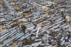  ?? AP photo ?? A war prosecutor observes collected parts of Russian rockets which were used to attack the city of Kharkiv, in Kharkiv, Ukraine on Thursday.