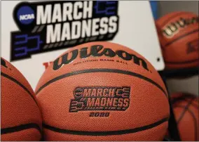  ?? NATI HARNIK - THE ASSOCIATED PRESS ?? Official March Madness 2020 tournament basketball­s are seen in a store room at the CHI Health Center Arena, in Omaha, Neb., Monday, March 16, 2020.