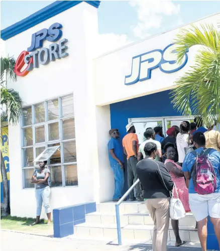  ?? RUDOLPH BROWN/PHOTOGRAPH­ER ?? Customers wait in line outside a JPS outlet in Kingston to pay thei electricit­y bills, on March 23, 2020.