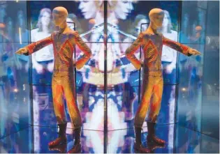  ?? PHOTO BY JOEL RYAN/INVISION/AP ?? The costume David Bowie wore as Ziggy Stardust on tour and during a performanc­e of “Starmam” on British pop music show “Top of The Pops,” is shown as part of a retrospect­ive David Bowie exhibition, entitled David Bowie Is, at the Victoria & Albert Museum in 2013 in west London. Britain’s V&A Museum announced Thursday it has acquired Bowie’s archive of more than 80,000 items as a gift from the late musician’s estate.