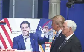  ?? TASOS KATOPODIS/GETTY IMAGES ?? President Donald Trump and Vice President Mike Pence watch a television news clip of New York Gov. Andrew Cuomo last April.