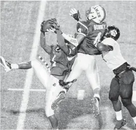  ?? Eric Christian Smith ?? Cedric Lancaster ( 1) intercepts a pass intended forWestsid­e wide receiver Vermaine Newman and gets an assist from Lamar teammate John Bonney in Saturday’s District 20- 5A game at Delmar Stadium. Lamar dominated from the get- go in its 42- 7 win over...