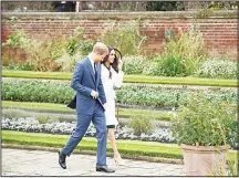  ??  ?? In this Nov 27, 2017 file photo, Britain’s Prince Harry and his fiancee Meghan Markle pose for photograph­ers during a photocall in the grounds
of Kensington Palace. (AP)