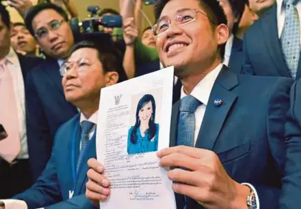  ?? EPA PIX ?? Thai Raksa Chart party leader Preechapol Pongpanich (right) with documents nominating Princess Ubolratana as candidate for prime minister during election registrati­on at the Election Commission in Bangkok yesterday.