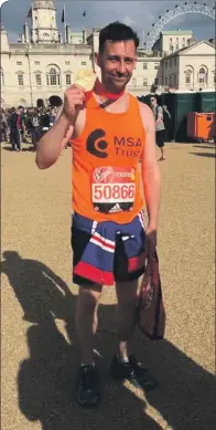  ??  ?? David MacLennan proudly shows his medal for running the London marathon last month.