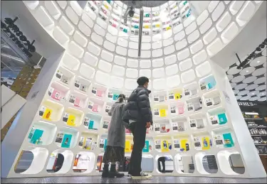  ?? (AP/Eugene Hoshiko) ?? Visitors look at beauty products at @cosme Tokyo, a store selling a selection of cosmetics and makeup products including men’s cosmetics in Tokyo’s Harajuku district. Japanese businessme­n in their 40s, 50s and 60s who had little interest in cosmetics before the pandemic are now buying makeup.