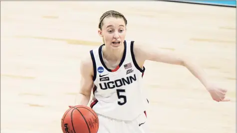  ?? Morry Gash / Associated Press ?? UConn’s Paige Bueckers dribbles during the first half of an NCAA college basketball game in the Sweet 16 round of the Women’s NCAA tournament on March 27 at the Alamodome in San Antonio.