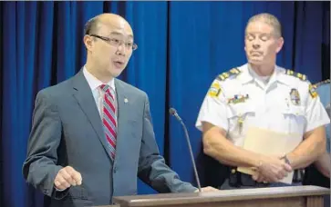  ?? Jennifer Simonson Minnesota Public Radio ?? RAMSAY COUNTY Atty. John J. Choi, with St. Paul Police Chief Tom Smith, announces criminal charges against the Archdioces­e of St. Paul and Minneapoli­s related to the case of former priest Curtis Wehmeyer.