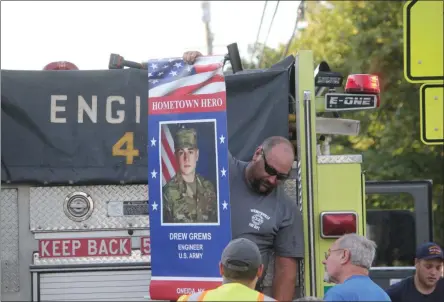  ?? PHOTOS BY CHARLES PRITCHARD - ONEIDA DAILY DISPATCH ?? Flags of Honor are installed by the Wampsville Fire Department on Court Street in Wampsville on Tuesday, Aug. 14.