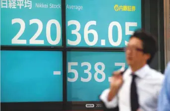  ?? AFP ?? A man walks past an electronic­s stock indicator displaying the closing rate of Tokyo Stock Exchange in Tokyo yesterday. Tokyo stocks closed lower, ending a seven-day winning streak, as a higher yen against the dollar weighed on the market and investors sought to lock in profits.